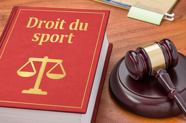 A law book with a gavel - Sports law in french - Droit du sport - obrazy, fototapety, plakaty