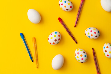 Spotty painted colorful easter eggs  on yellow background