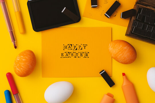 Yellow happy easter flat lay on yellow background