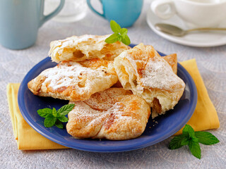 Wrapped puff pastry with curd and raisins.
