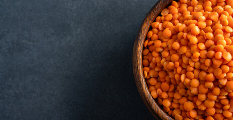 Uncooked lentils on black background