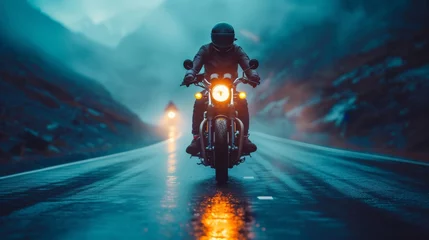 Deurstickers The biker's motor roars as he races up the mountain road, the vintage bike's engine reverberating in the still night air. © tonstock