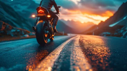Zelfklevend Fotobehang As the biker revs up his vintage motorbike, the sound of the engine fills the air, a testament to the power and freedom of the open road at sunset. © tonstock