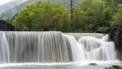 waterfall in the forest Lijiang China