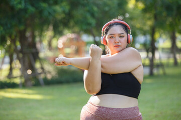 Asian female overweight in sportswear and headphone aerobic exercise physical activity. women plus...