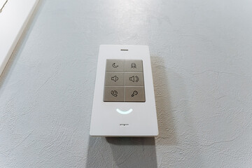 White remote control and electronics on table with various accessories