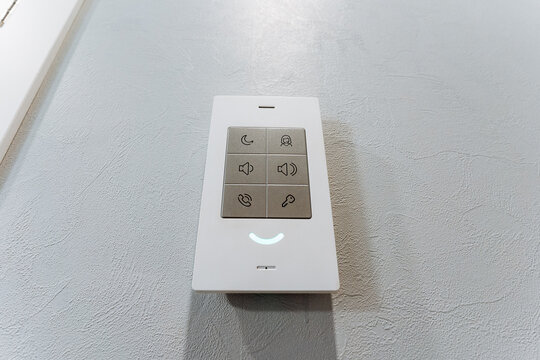 White remote control and electronics on table with various accessories