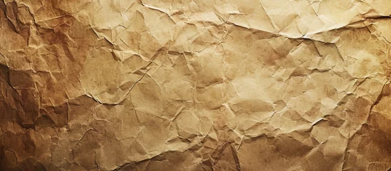 Afwasbaar fotobehang A close-up of a crumpled brown paper, resembling a pattern found in natural materials like beige bedrock or soil. © AkuAku