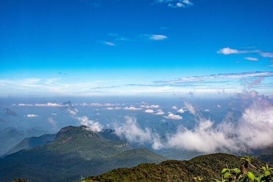 the clouds are rolling through the valley below and below the clouds