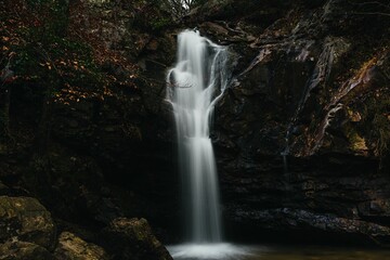 Fototapeta na wymiar Scenic view of a waterfall cascading down between large rocks