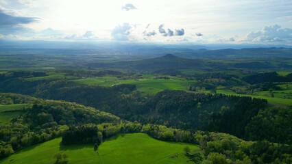 Captivating aerial view of the green valley with lush vegetation and hills. Saint-Etienne-sur-Usson.