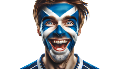 man soccer fun portrait with painted face of scottish national flag isolated on transparent background