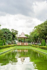 a gazebo is reflected in a lake at the park