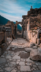 an old stone walkway in an ancient city area with mountains in the background