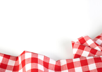 Red checkered picnic cloth folded top view on white background. Gingham crumpled towel empty copy...