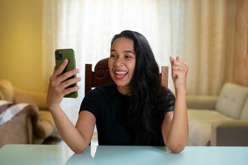 a woman is taking a selfie at a table with her phone