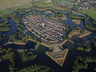 Fototapeta premium Scenic aerial view of the Fortress town of Naarden-Vesting surrounded by a tranquil lake
