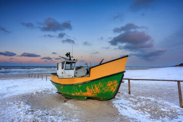 Naklejka na ściany i meble Fishing boats on the Baltic Sea beach in Jantar at winter. Poland