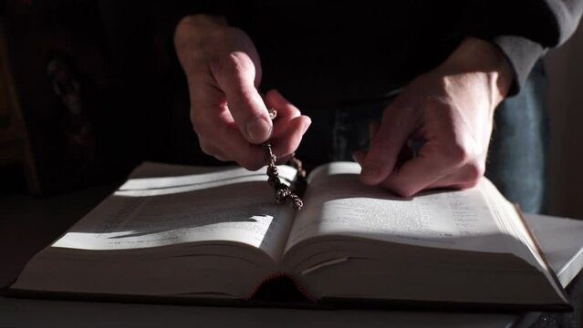 A man is reading the Holy Bible. The concept of prayer, religion, faith