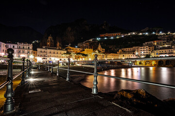 the walkway over the sea leads to the center of the small village of Amalfi offers at night