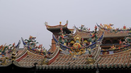 Ancient building with traditional Asian architecture on the roof of it