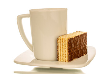 One sweet chocolate wafer on a ceramic saucer with a cup, macro, isolated on a white background.