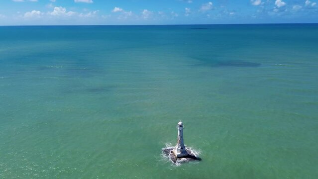 Drone footage of Pedra Seca Lighthouse  in north of Joao Pessoa, Paraiba , Brazil with blue sky