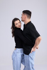 This captivating minimalist portrait features a couple in a quiet embrace, bathed in soft light.