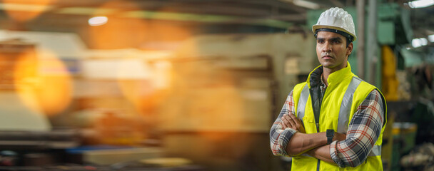 Portrait of smiling indian industrial worker man with helmet crossed arms in industry factory .happy confidence asian india male Engineer standing in manufacturing. good positive emotion job - obrazy, fototapety, plakaty
