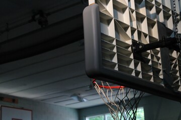 Low-angle view of a basketball hoop in a gymnasium