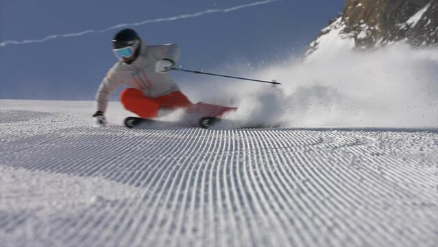 Man practicing piste on sloping icy land, slow motion shot