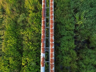 Aerial view of rusty pipes with nature in the background in Lublin, Poland
