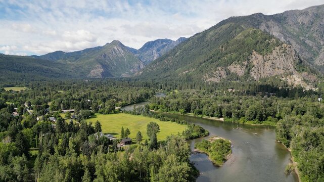Tranquil Leavenworth wenatchee river through lush green forested mountains in the valley