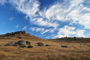 Expansive rural landscape with a rolling field of lush grass