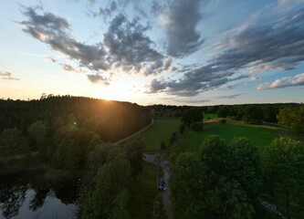 Drone view of a lake surrounded by greenery in the countryside