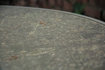 Macro shot of a grungy table surface, showing dirt and debris