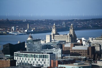 Fototapeta premium the skyline of liverpool in england with some buildings and the water