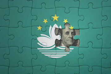 puzzle with the national flag of Macau and usa dollar banknote. finance concept