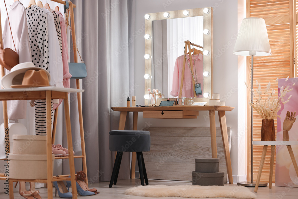 Canvas Prints Makeup room. Stylish dressing table with mirror, chair and clothes rack indoors