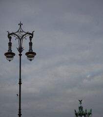 Fototapeta na wymiar Old streetlight on the street on a cloudy evening