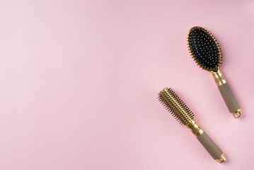 Two hairbrush on a pink background. Copy space.
