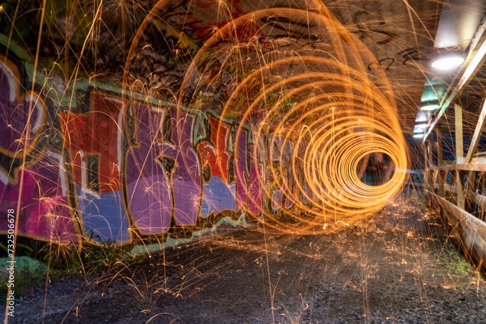 Wall mural Night scene featuring a burning fire created by spinning steel wool with a long exposure.