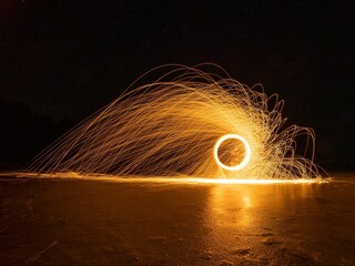 Long-exposure of a yellow burning steel wool at night