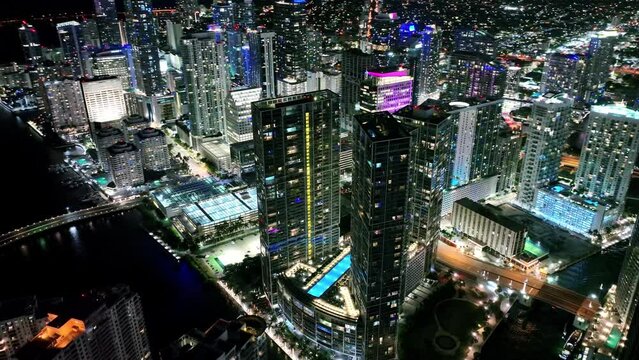 Drone footage of colorful Miami downtown Financial district and traffic on streets at night