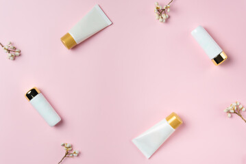 Set of white tubes on a pink background, top view