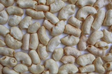 Fried macaroni crackers, on white background, flat lay or top view