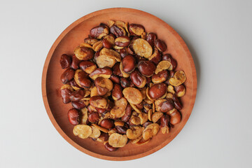 Kacang koro, or jack bean. Cooked and served with salt. On wooden plate, isolated on white background, flat lay or top view