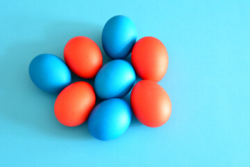 painted blue and red easter eggs isolated on blue background  