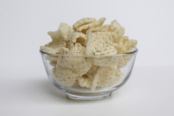 Crackers in net shape, in transparent glass bowl. isolated on white background