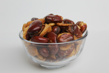 Kacang koro, or cooked jack bean, in a transparent glass bowl, isolated on white background